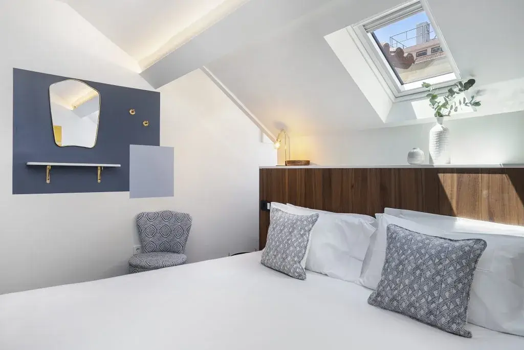 A bright bedroom under the skylight at Casa Almada