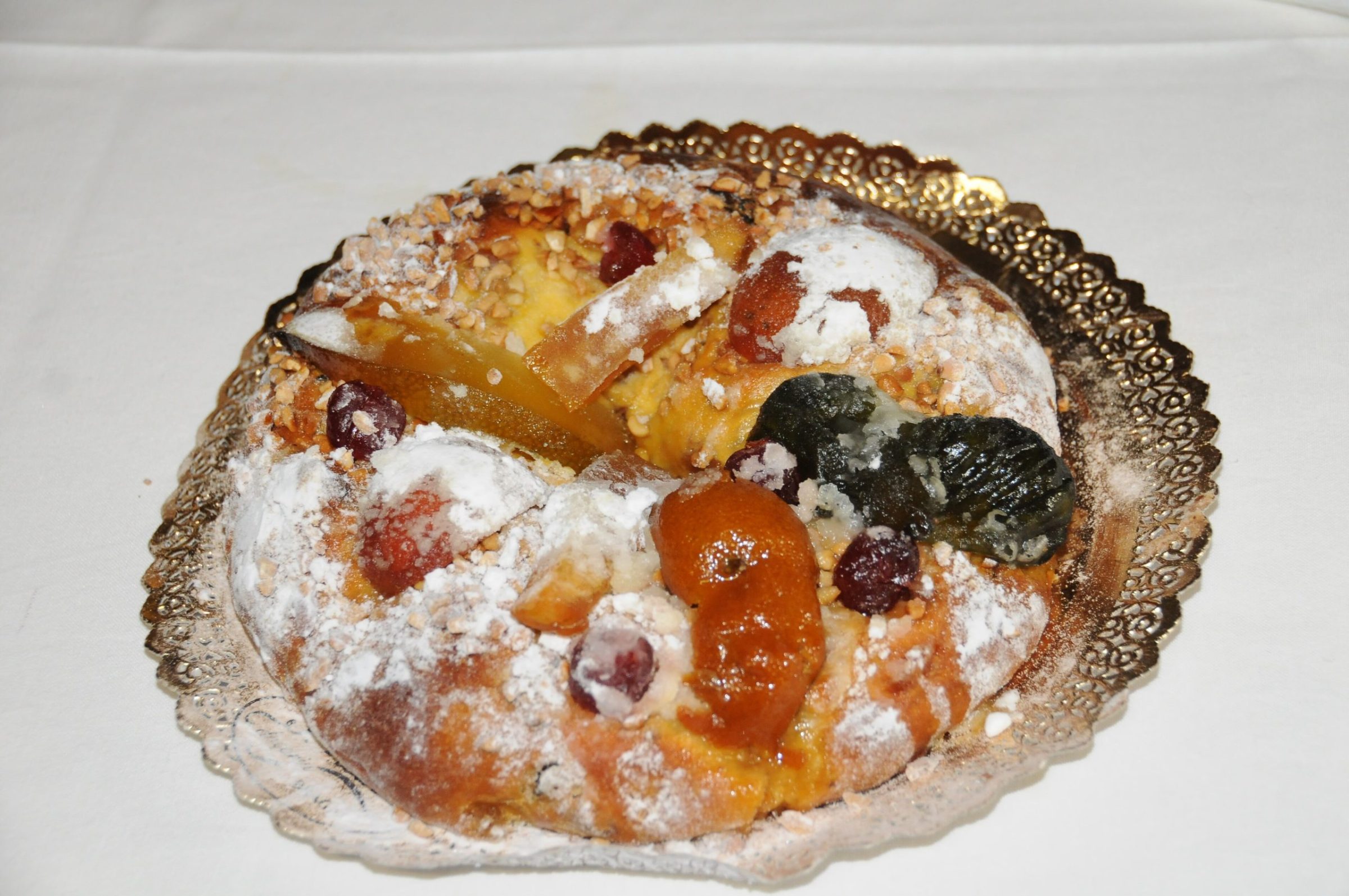 A bolo-rei, the Portuguese Christmas king cake, topped with candied fruit and sugar