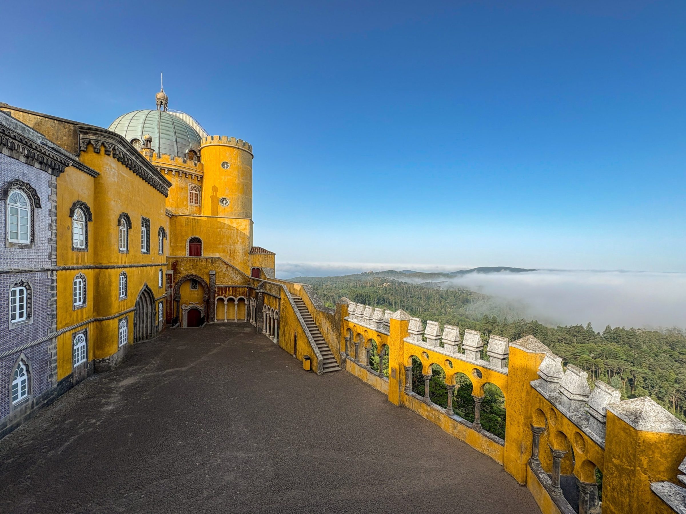 Pena Palace in Sintra above a sea of morning mist