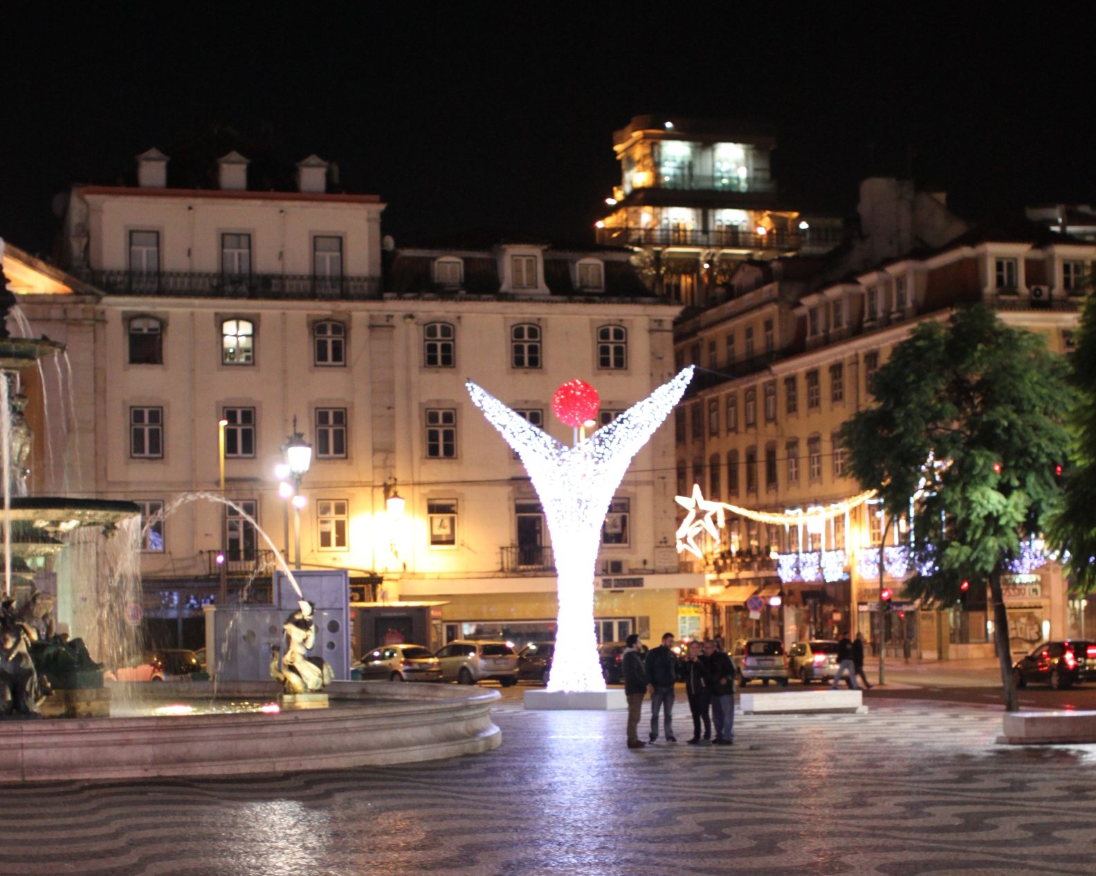 Christmas lights on Rossio square in Lisbon with the Santa Justa Lift behind